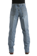 Rear view of a person wearing light blue denim jeans with a black top and brown shoes, shown against a plain white background.