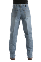 Rear view of a person wearing light blue denim jeans with a black top and brown shoes, shown against a plain white background.