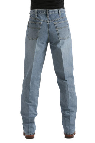 Rear view of a person wearing light blue denim jeans with a black top and brown shoes, shown against a plain white background.