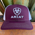 A maroon and white trucker hat with white embroidered Ariat logo and text, 
