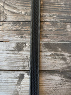 Black leather with full basketweave tooling, scalloped edge detail, and white contrast stitching — finished with a large engraved silver western buckle. A clean, classic western belt with sharp contrast and serious handcrafted character.