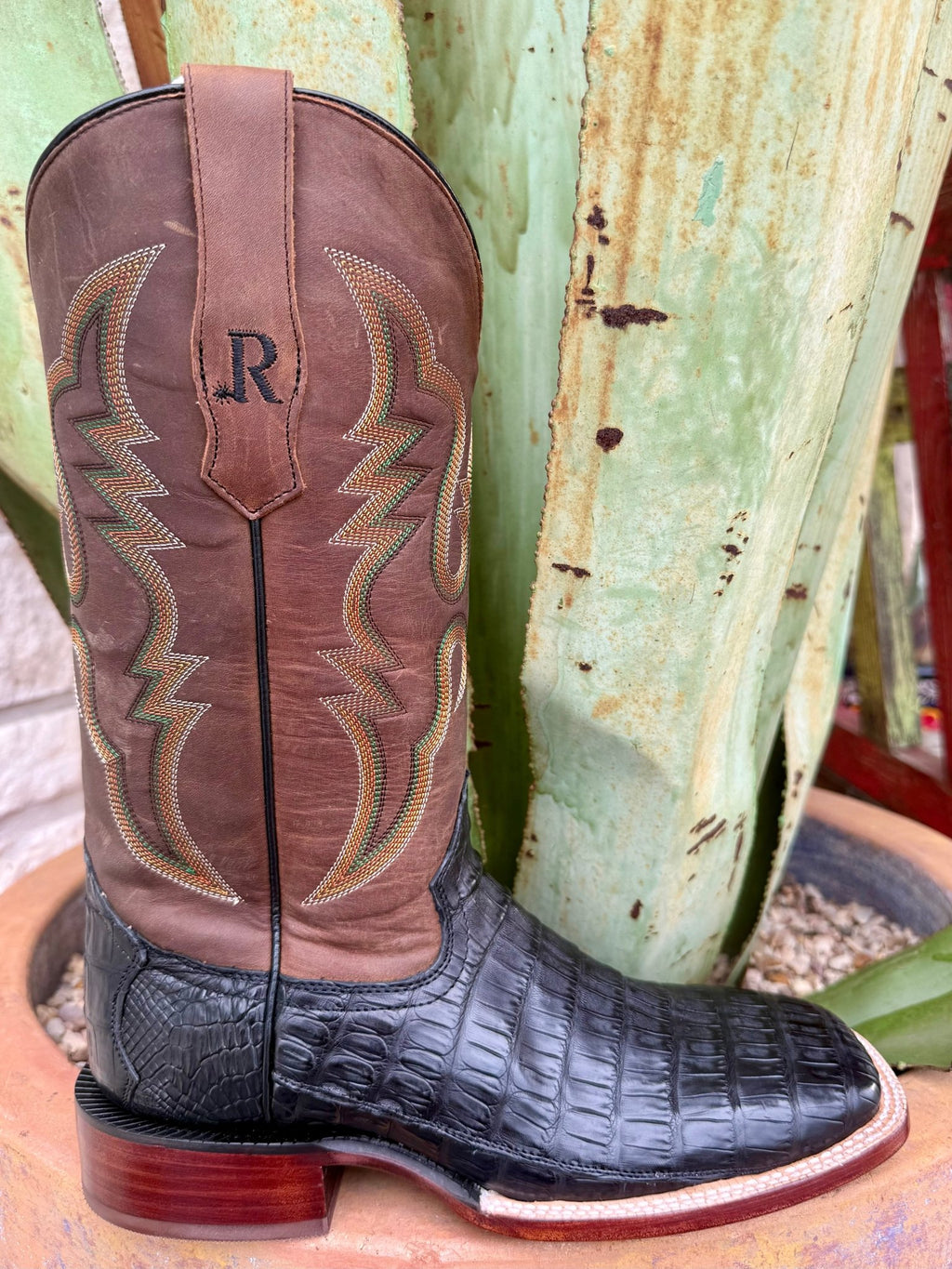 Men’s R. Watson exotic western boot in black caiman tail with Arizona tan cowhide shaft, built from genuine caiman leather for lasting strength, featuring a wide square toe and comfort insole for everyday wear – RW3000-2. Available at Blair’s Western Wear, Marble Falls, TX.