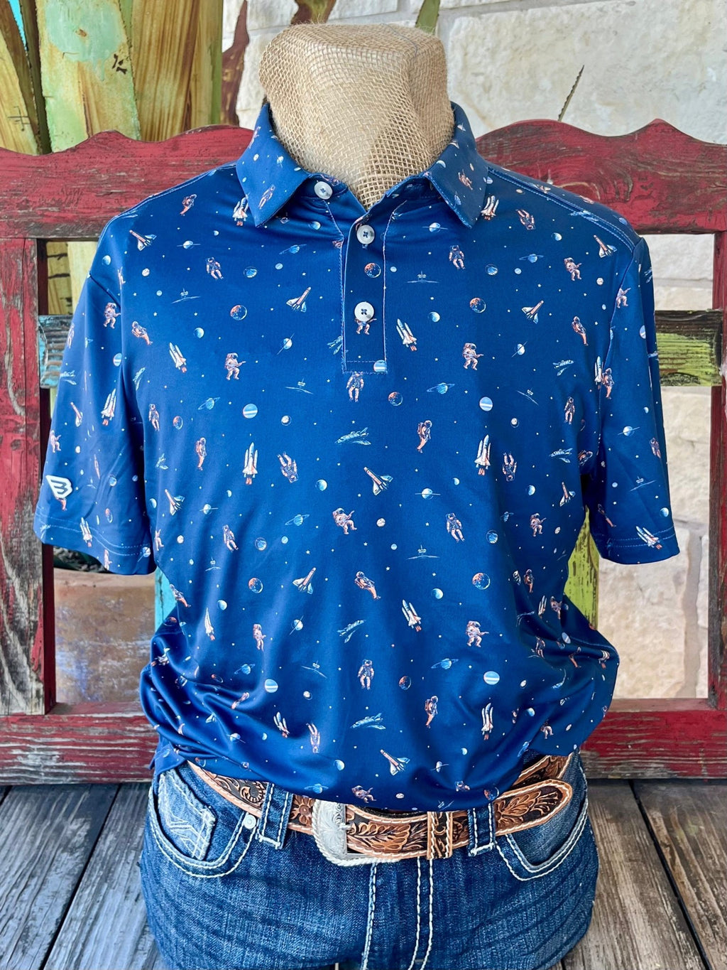 Men's Burlebo Western Wear Short Sleeve Polo Shirt in navy and orange, featuring a unique astronaut and space-themed print with durable construction - PPMOON. Available at Blair's Western Wear, Marble Falls, TX.