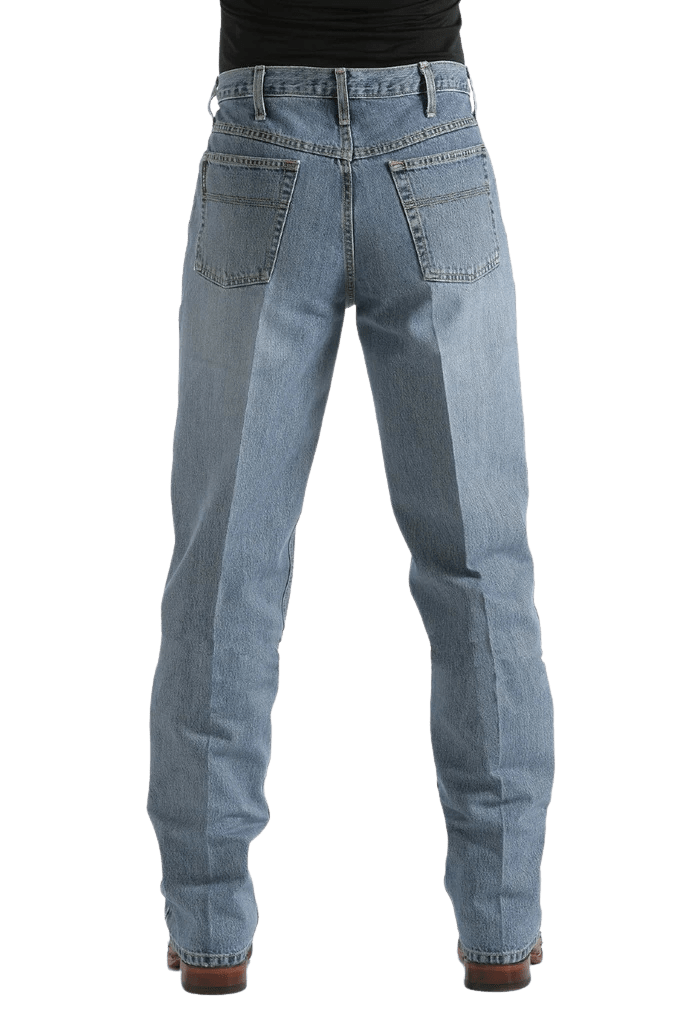 Rear view of a person wearing light blue denim jeans with a black top and brown shoes, shown against a plain white background.