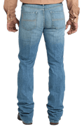 Men's slim fit stretch denim jean in medium stonewash with sanding and whisker details and boot-friendly leg opening — Blair's Western Wear Marble Falls TX