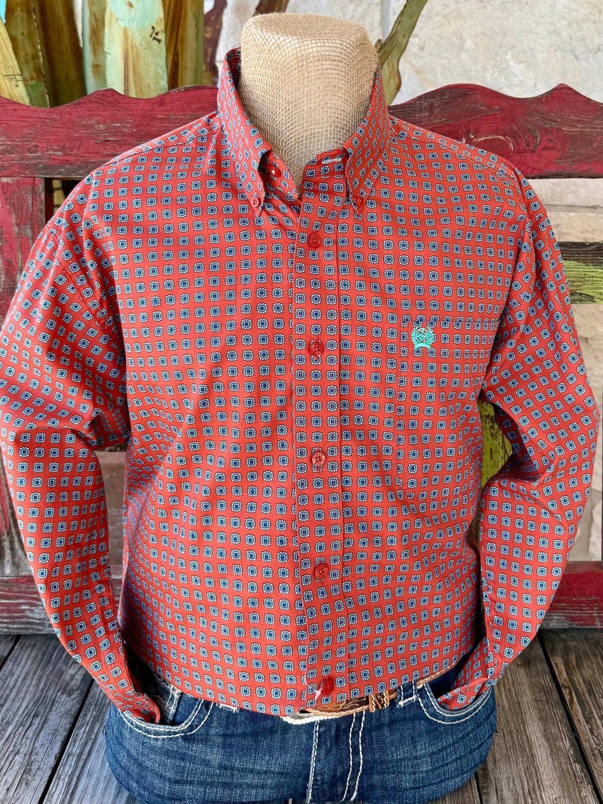 Men’s CINCH long sleeve button-down print shirt in brick and blue, made from breathable cotton with a bold geometric medallion pattern, featuring turquoise logo embroidery and red buttons – MTW1105935. Available at Blair’s Western Wear, Marble Falls, TX.