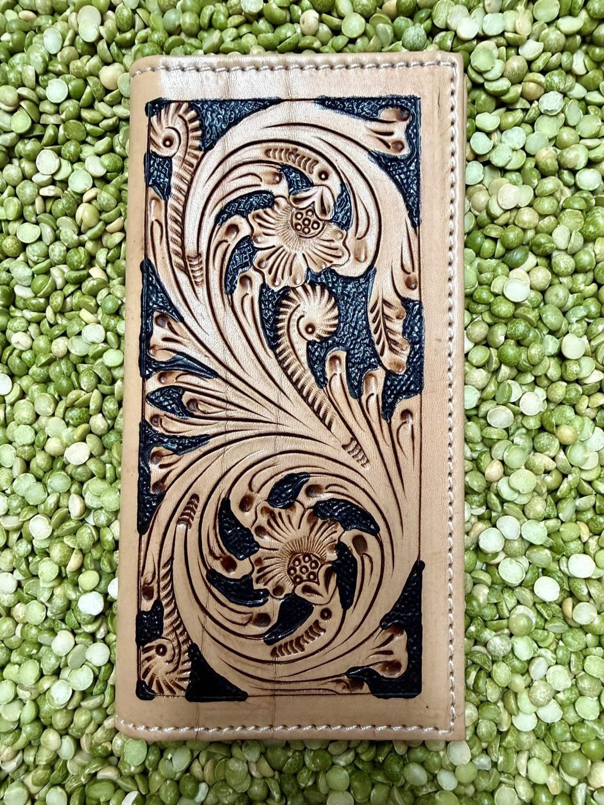 Natural and black leather checkbook wallet with floral scroll tooling and stitched edges — Blair's Western Wear Marble Falls TX