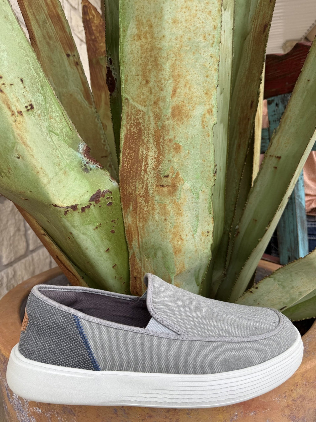 Men's grey canvas slip-on shoe with a rounded toe, cushioned collar, elastic laces, and lightweight contrasting outsole — Blair's Western Wear Marble Falls TX