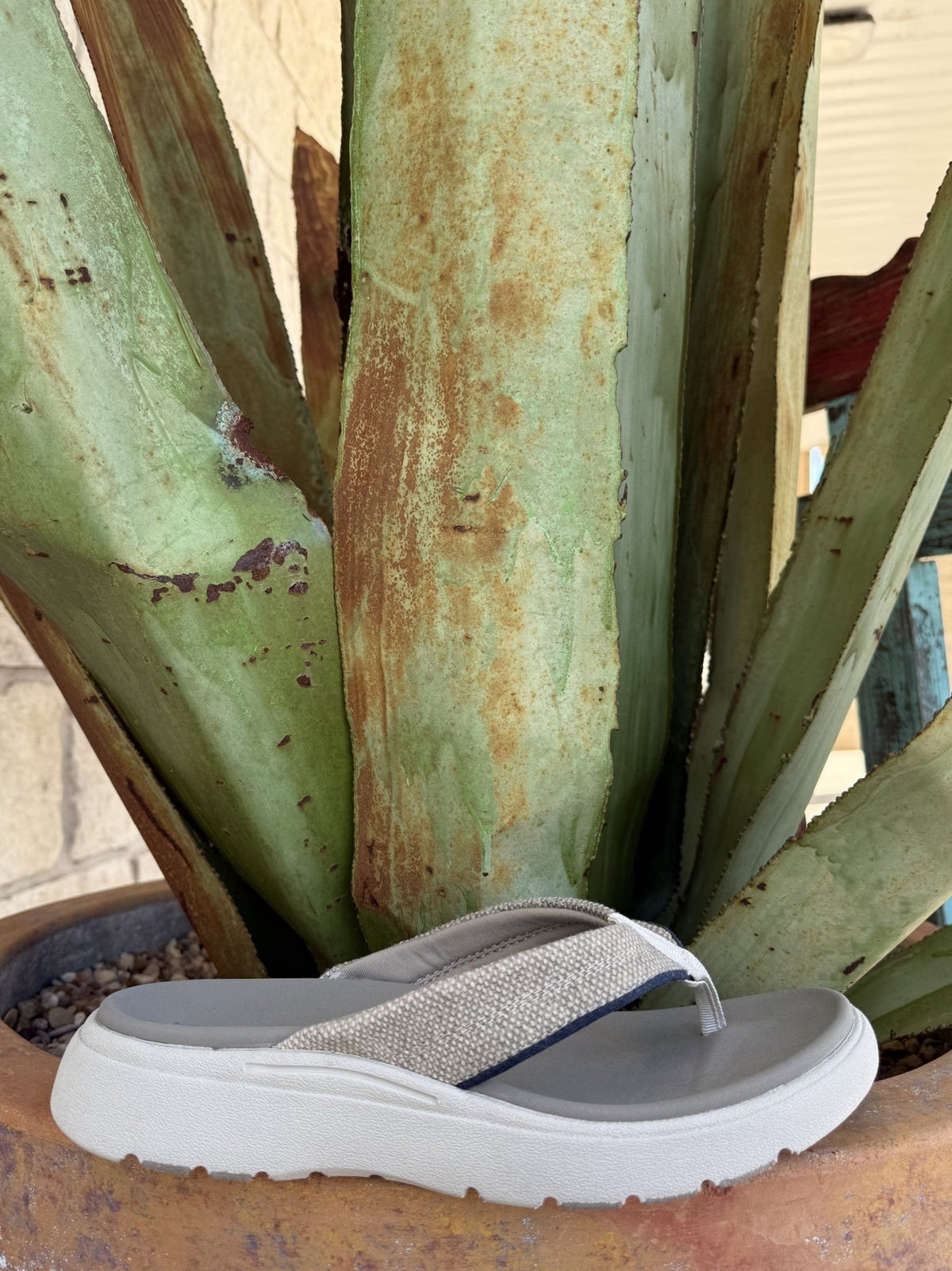 Men's tan canvas flip flop with wide strap, molded footbed, lightweight EVA outsole, and rubber traction inserts — Blair's Western Wear Marble Falls TX