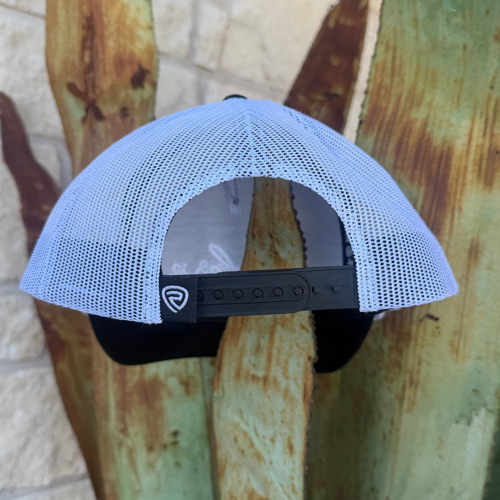 A white mesh trucker cap with a black adjustable strap and a small  logo patch,