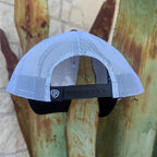 A white mesh trucker cap with a black adjustable strap and a small  logo patch,