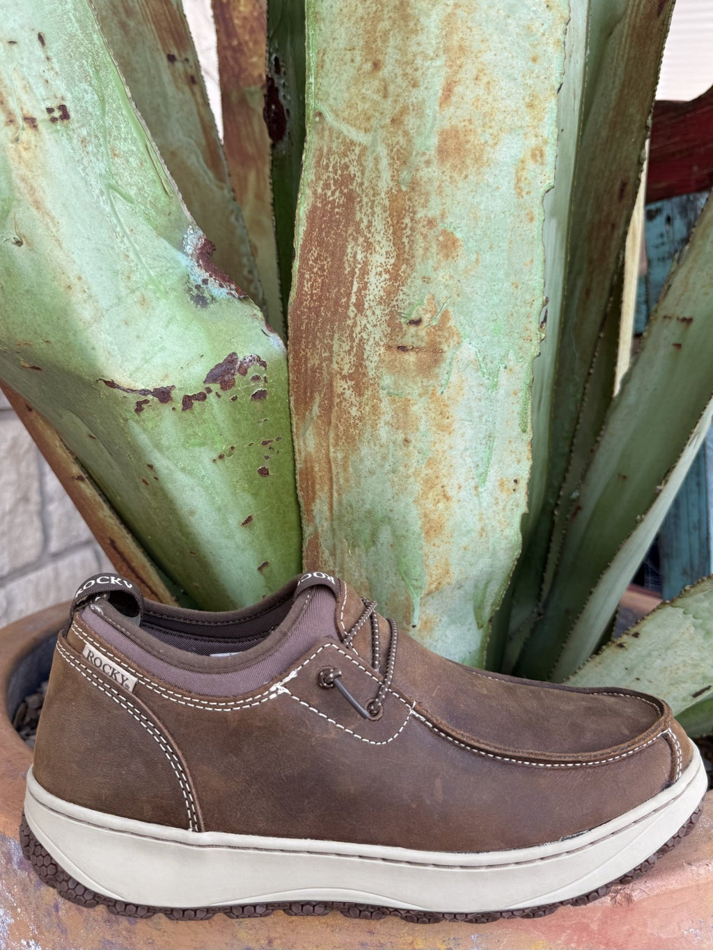 Men's brown full-grain leather slip-on shoe with dual pull tabs, contrast stitching, rounded moc toe, and honeycomb-tread rubber outsole — Blair's Western Wear Marble Falls TX