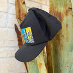 A black cap with a colorful embroidered patch on the front