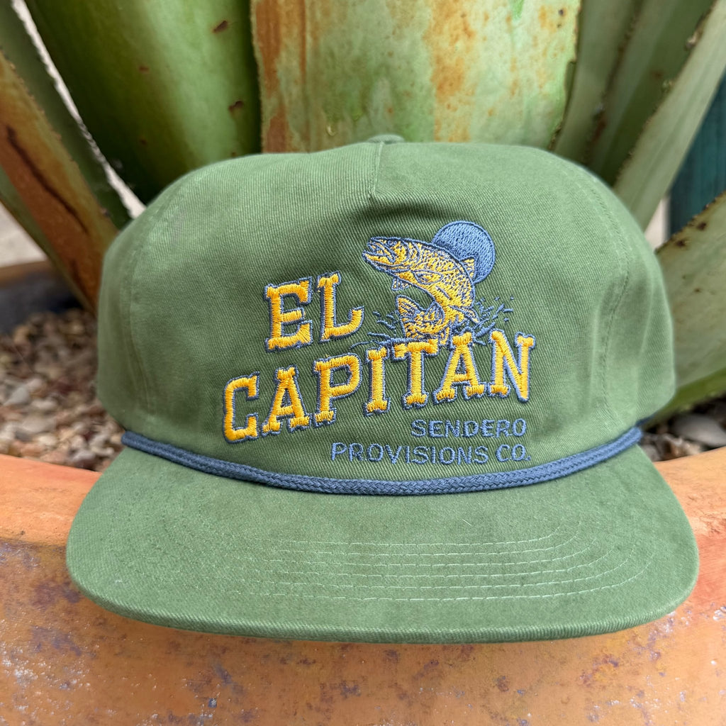 An olive green cap with 'EL CAPITAN' embroidered in yellow and blue, featuring a fish graphic and 'SENDERO PROVISIONS CO' text