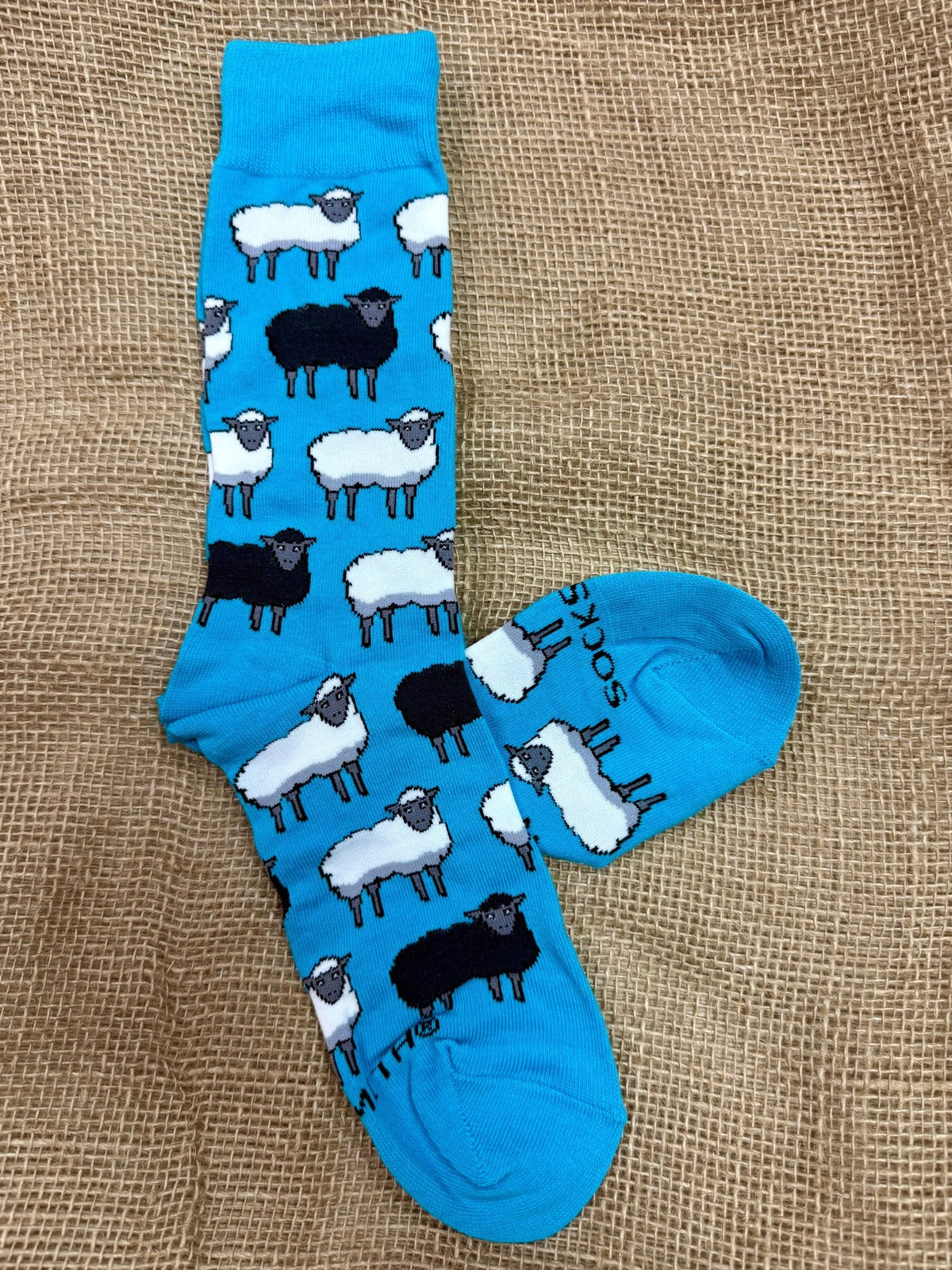 Men's Socksmith novelty crew socks in blue, crafted with a soft cotton blend for all-day comfort, featuring black and white sheep patterns with a stay-put cuff - MNC3046. Available at Blair's Western Wear, Marble Falls, TX.