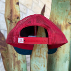 A red trucker-style cap viewed from the back, featuring a red mesh crown and adjustable red plastic strap
