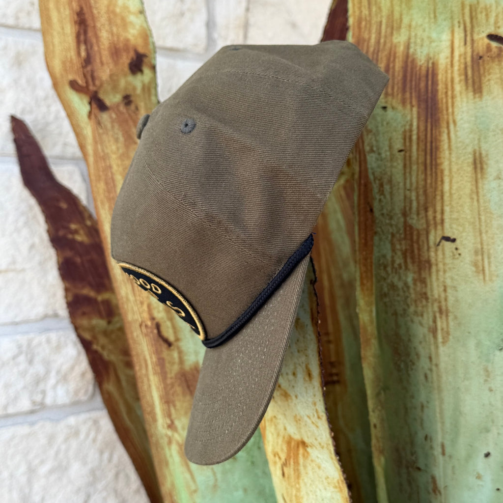 An olive cap with a curved brim and a black rope detail
