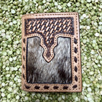 Men's natural-tan trifold wallet with dark basketweave tooling, gray-and-black hair-on-hide front panel, decorative dark lacing, and stitched edges — Blair's Western Wear Marble Falls TX