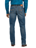 Rear view of a man wearing blue denim jeans with a brown leather belt and a bright blue long-sleeve shirt, shown against a plain white background.