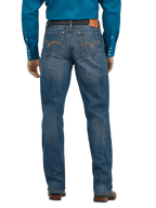 Rear view of a man wearing blue denim jeans with a brown leather belt and a bright blue long-sleeve shirt, shown against a plain white background.