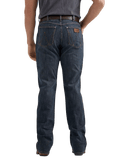 Rear view of a person wearing dark blue denim jeans with a brown leather patch on the back pocket, paired with a dark gray t-shirt and brown belt, against a plain white background.
