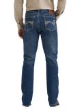 Rear view of a person wearing blue denim jeans with a beige long-sleeve shirt, shown against a plain white background.