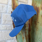 A blue cap with white embroidered lettering 