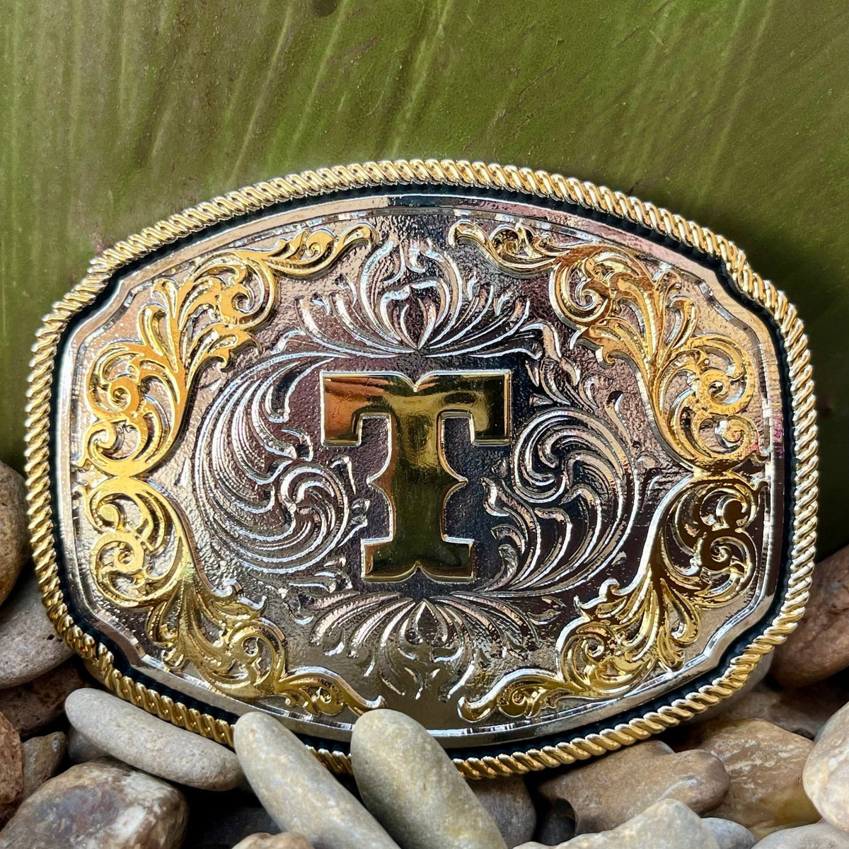 Montana Silversmiths Western Belt Buckle in silver and gold, featuring intricate engravings and a prominent 'T' initial - A1047T. Available at Blair's Western Wear, Marble Falls, TX.