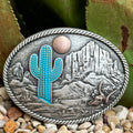 Men’s Montana Silversmiths Western Buckle in Silver, bold turquoise cactus centerpiece, with rose gold-tone sun detail and raised mountain and skull accents - A825. Available at Blair's Western Wear, Marble Falls, TX.