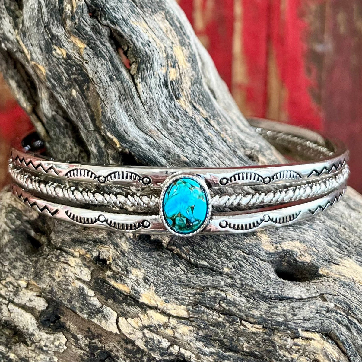 Montana Silversmiths Turquoise Strand Cuff in silver, featuring a central turquoise stone surrounded by a rope design, crafted with high-quality materials - BC6104. Available at Blair's Western Wear, Marble Falls, TX.