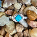 Ladies Montana Silversmiths ring with turquoise Crown Glacier stone in silver, featuring a radiant turquoise center framed by crystals, with rhodium-plated band for lasting shine - RG6313. Available at Blair's Western Wear, Marble Falls, TX.