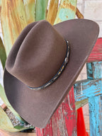 Men’s Resistol Whitmore 4X cowboy hat in oak brown, crafted from wool felt for durability, with a 4 1/4" brim for sun protection, and finished with a woven hatband featuring silver-tone concho detail – SBWTMR7242. Available at Blair's Western Wear, Marble Falls, TX.