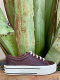 Full side profile — dark brown floral scroll tooled leather, white laces, chunky white platform with black stripe