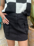 Ladies EEsome cargo mini skirt in black, featuring durable cotton fabric and functional side cargo flap pockets with belt loops for an adjustable fit – DZ25C920. Available at Blair's Western Wear, Marble Falls, TX.