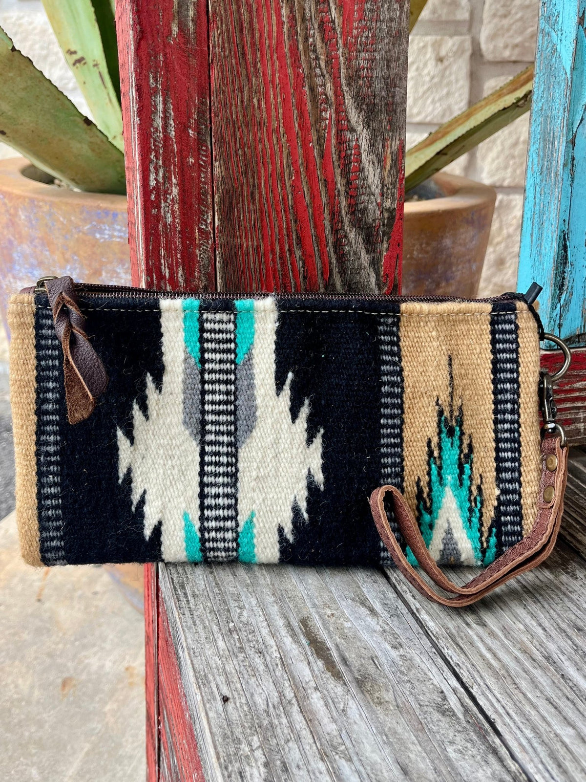 American Darling Blanket Aztec Wrist Pouch in tan, black, and turquoise, crafted with durable hand-woven wool and genuine full-grain leather, featuring a secure zipper and leather wrist strap - ADBG344BC. Available at Blair's Western Wear, Marble Falls, TX.