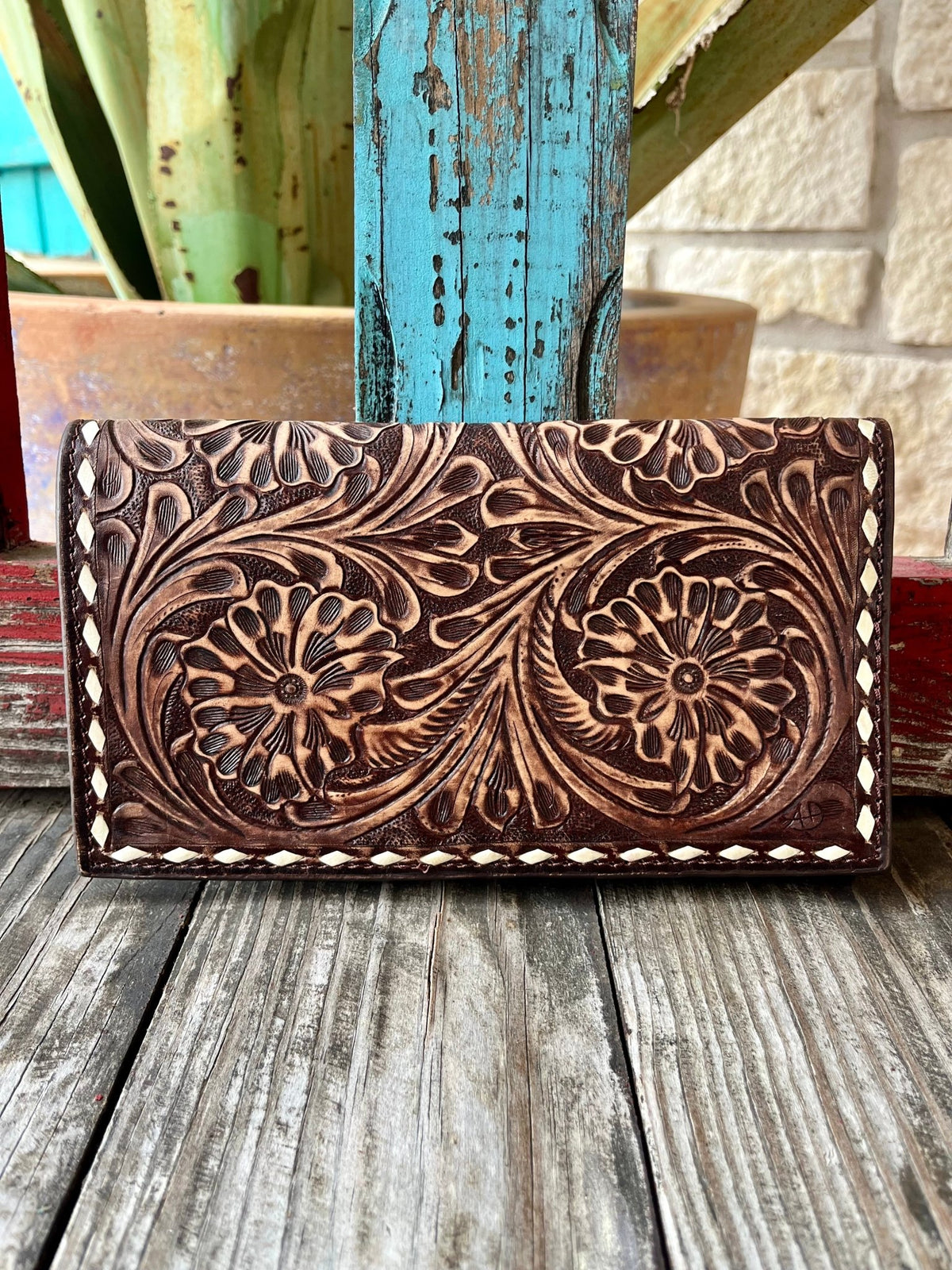Women's American Darling Clutch Wallet in chocolate and white, showcasing hand-tooled, full-grain genuine leather, with a secure YKK zipper and removable shoulder strap - ADBGZ584B. Available at Blair's Western Wear, Marble Falls, TX.