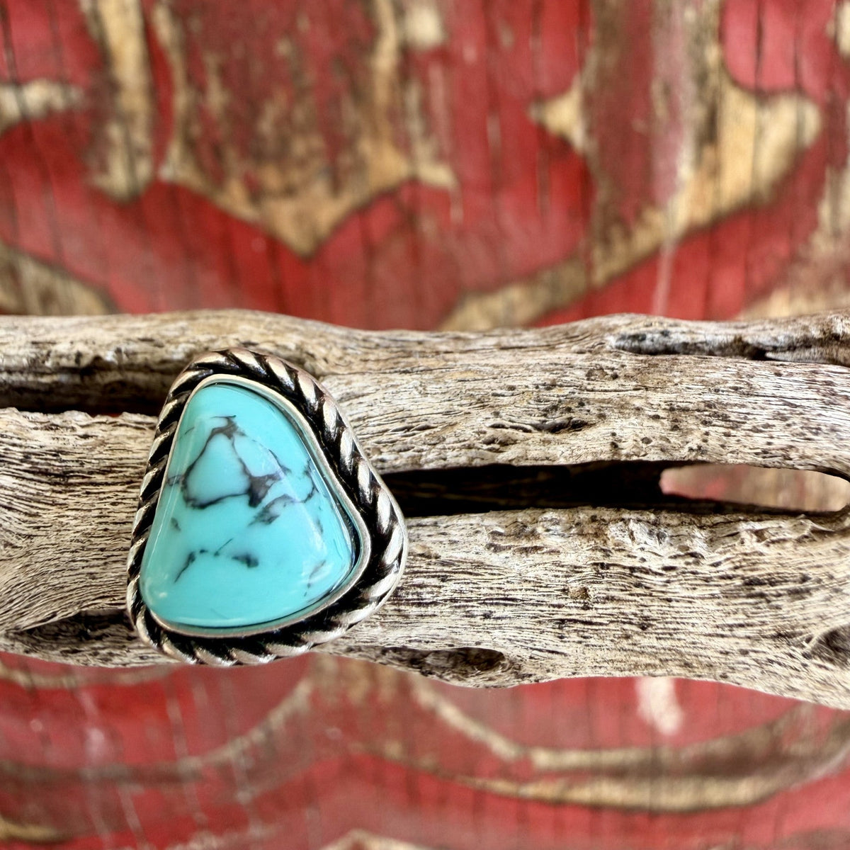 Silver-tone rounded triangle stud earring with turquoise-colored center, branching dark veining, and twisted rope-style edging — Blair's Western Wear Marble Falls TX