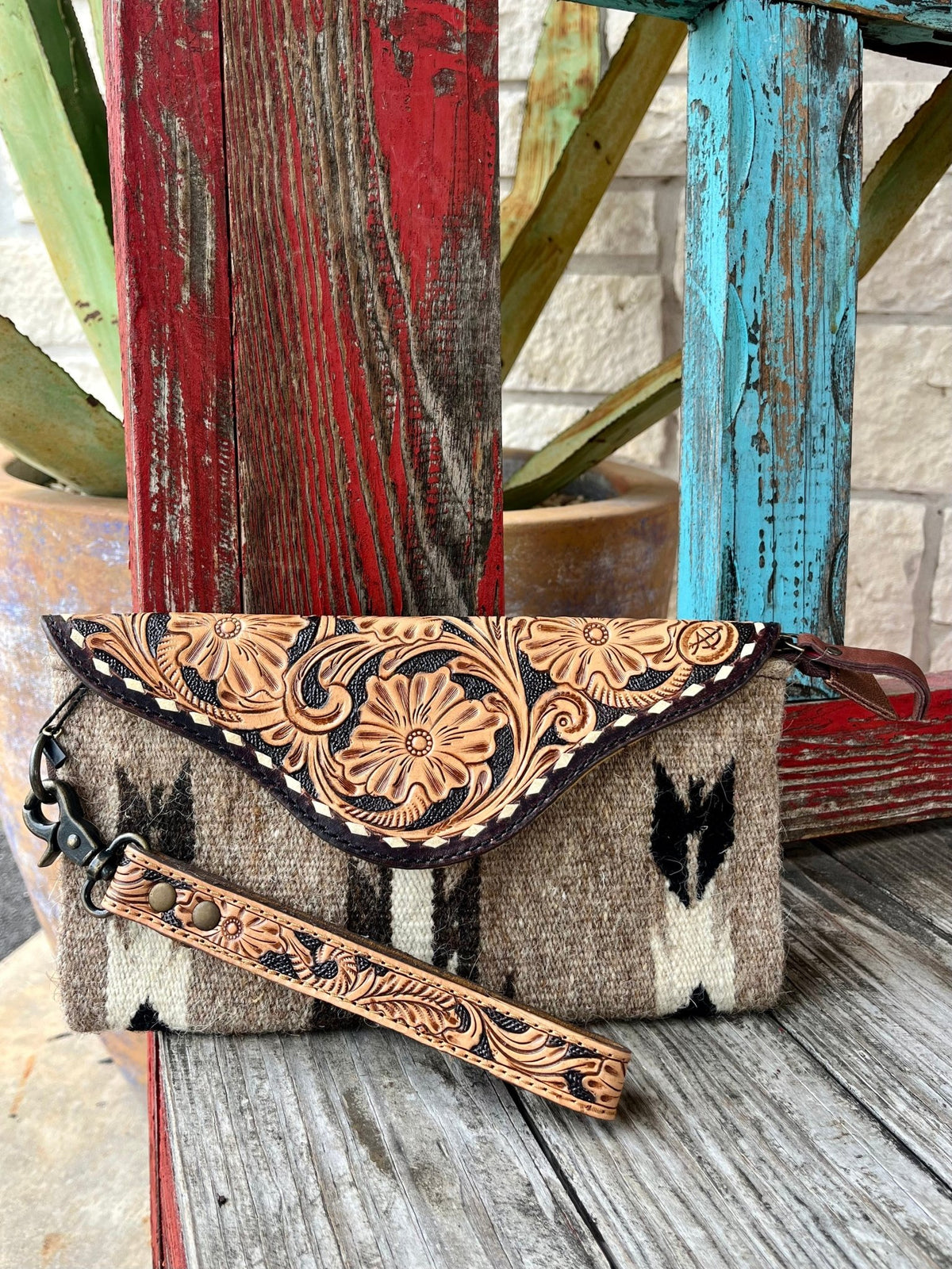 Women's American Darling Tan/Black/Natural Leather Clutch, crafted from vegetable-tanned genuine cowhide leather with hand-tooled floral designs and a handwoven wool saddle blanket - ADBG1477C. Available at Blair's Western Wear, Marble Falls, TX.