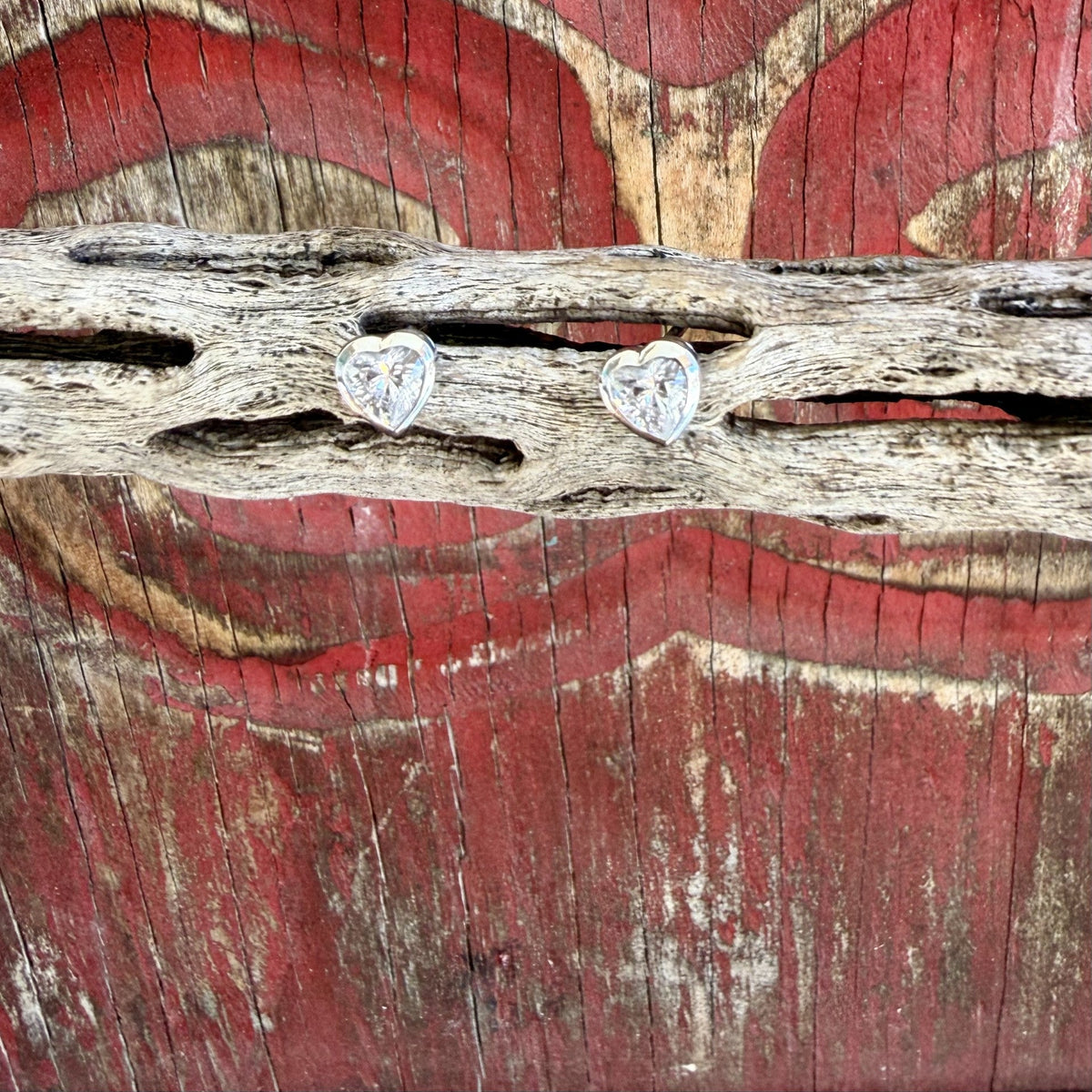 Women's tiny heart-shaped stud earrings with clear faceted centers and smooth silver-tone heart borders — Blair's Western Wear Marble Falls TX