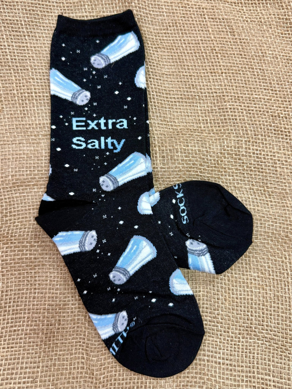 Women’s Socksmith novelty crew socks in black, featuring salt shaker design and “Extra Salty” wording, with soft cotton-blend comfort and reinforced heel for durability - WNC3399. Available at Blair's Western Wear, Marble Falls, TX.