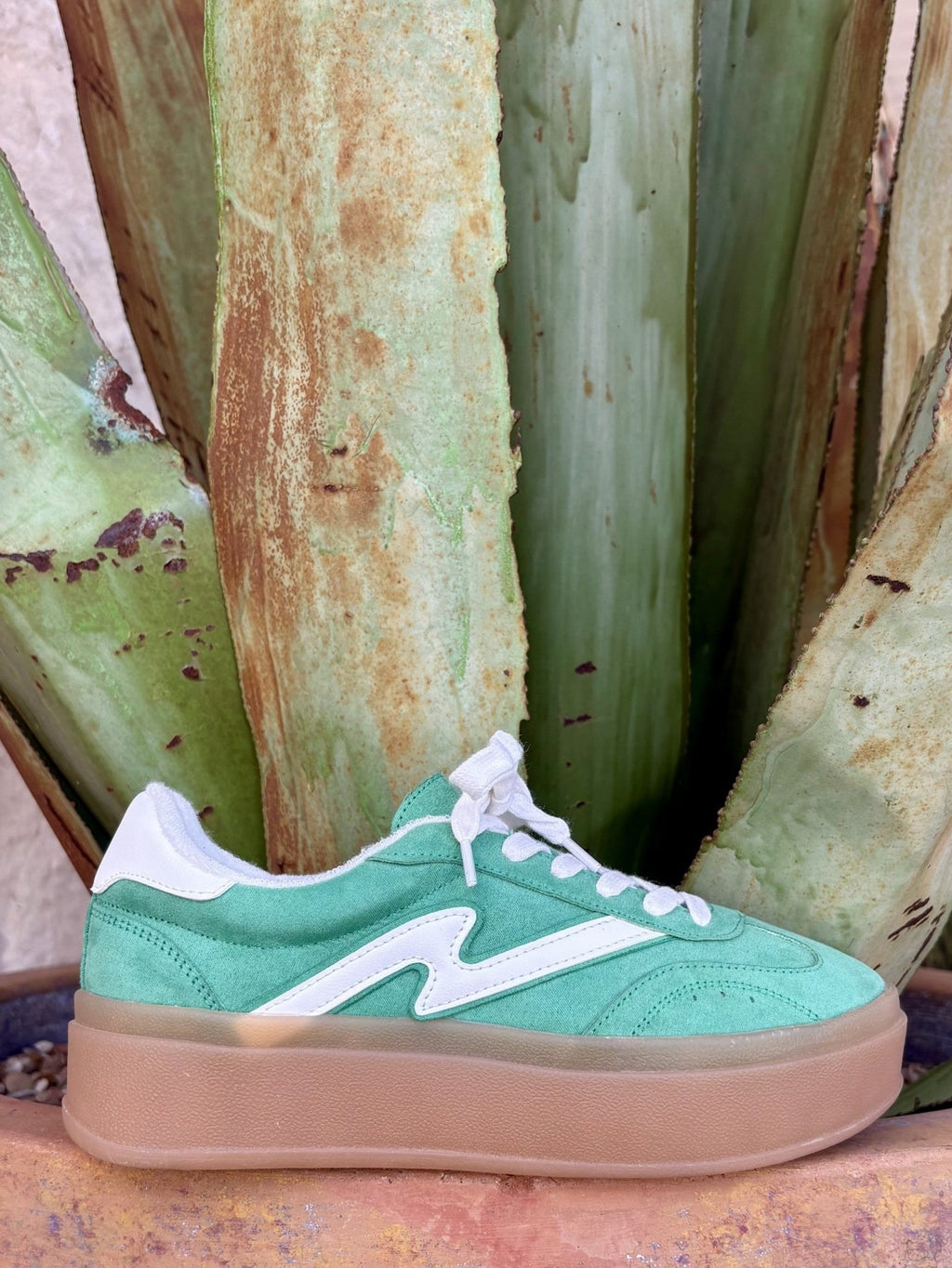  Emerald green side profile — white M panel, white laces, gum sole, agave backdrop