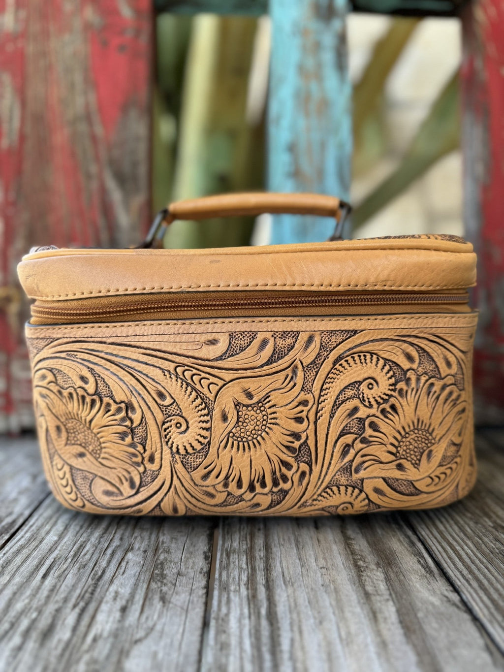 Ladies American Darling Jewelry/Makeup Case in tan with floral tooled leather, features a soft structured shape with secure zippered closure, and includes multiple interior compartments - ADBG1251G. Available at Blair's Western Wear, Marble Falls, TX.