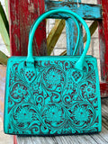 ADBGZ732B — Women's structured turquoise and dark brown full-coverage floral and scroll hand-tooled leather satchel with vibrant turquoise dye on raised carved surfaces over dark chocolate/espresso brown leather base, multiple large circular floral medallions with sweeping acanthus scroll and leaf carving across entire front panel, smooth matching turquoise leather top handles, top-center zip closure with leather pull tab, dark chocolate leather base trim, and American Darling AD brand stamp on lower right 
