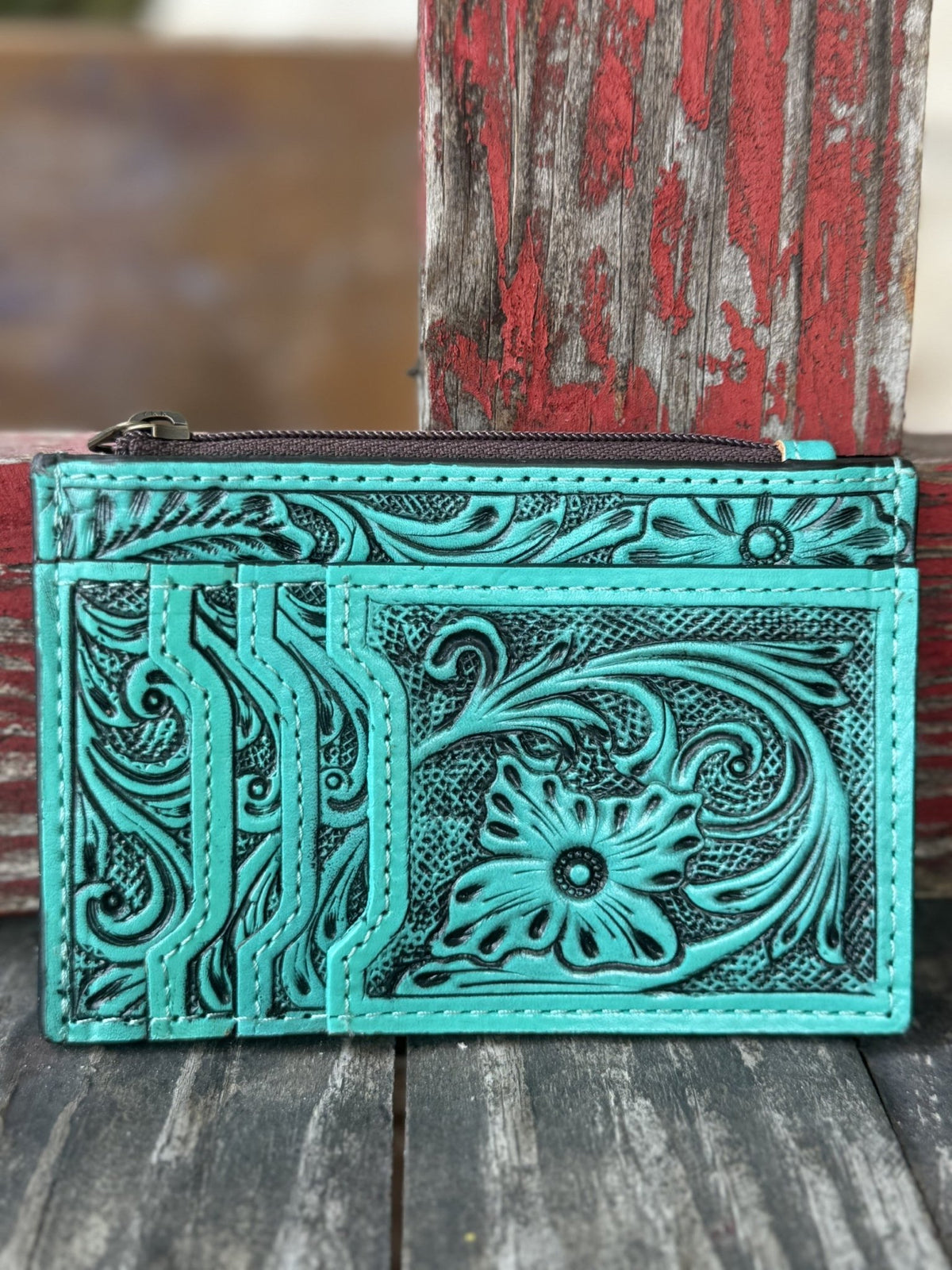  ADBG1506I — Women's vibrant turquoise hand-tooled leather cardholder wallet showing large floral and scroll motif with dark black antiqued contrast on the front, three fanned card slots on the left panel, and zippered top pouch — Blair's Western Wear Marble Falls TX
