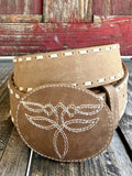 Women's tan Western belt with cream whipstitch edging and oval covered buckle with boot-stitch-inspired embroidery — Blair's Western Wear Marble Falls TX