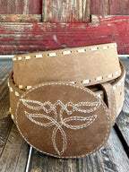 Women's tan Western belt with cream whipstitch edging and oval covered buckle with boot-stitch-inspired embroidery — Blair's Western Wear Marble Falls TX