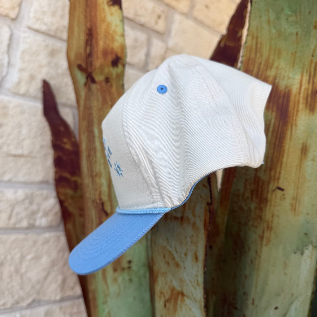 A light blue and oof-white cap with a small blue embroidered logo